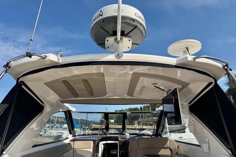  Yacht Photos Pics 2013 Regal 35 Sport Coupe boat interior with Garmin radar, docked under clear blue sky.