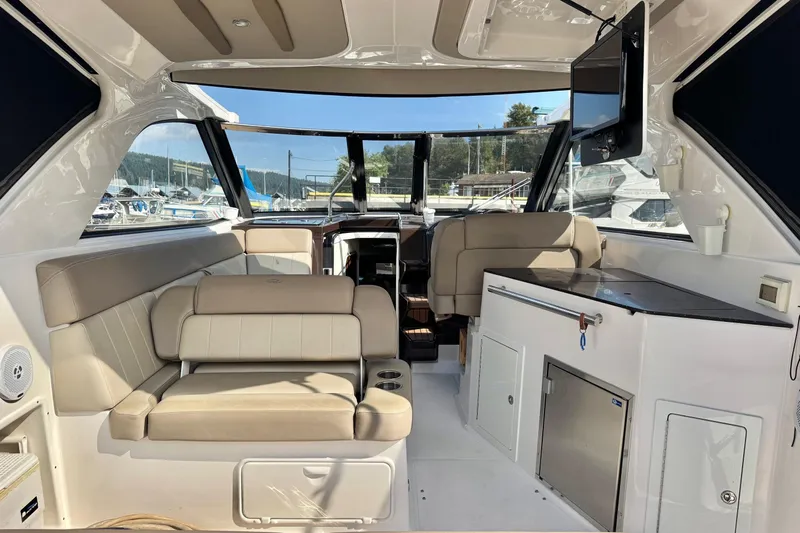  Yacht Photos Pics Interior of a 2013 Regal 35 Sport Coupe yacht with seating and kitchenette.