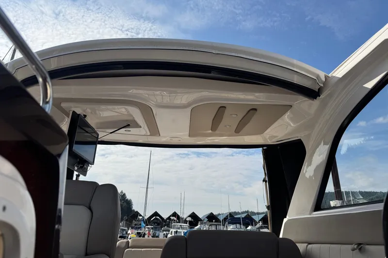  Yacht Photos Pics 2013 Regal 35 Sport Coupe interior with open sunroof, marina view, and clear sky.