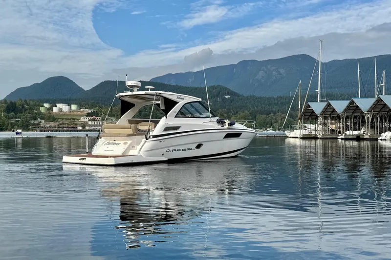  Yacht Photos Pics 2013 Regal 35 Sport Coupe on calm water with scenic mountain backdrop.