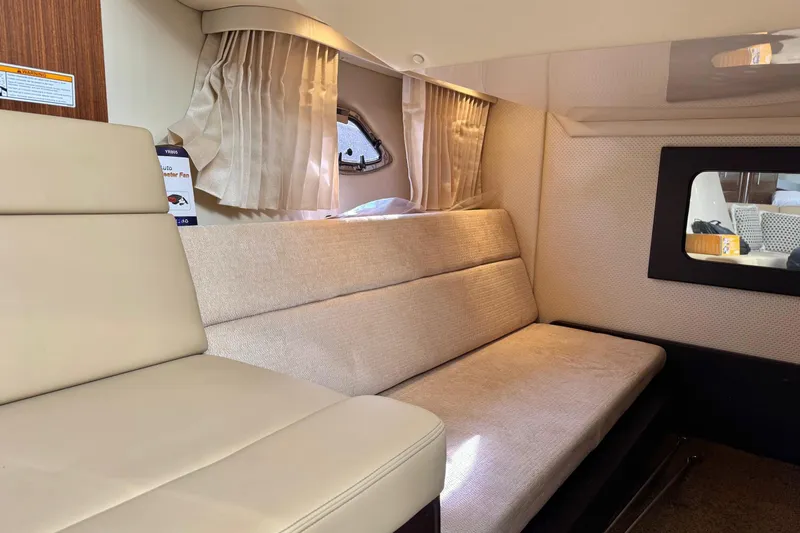  Yacht Photos Pics Interior of 2013 Regal 35 Sport Coupe with beige seating and window view.