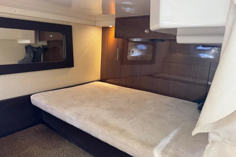  Yacht Photos Pics 2013 Regal 35 Sport Coupe cabin interior with bed and wooden paneling.