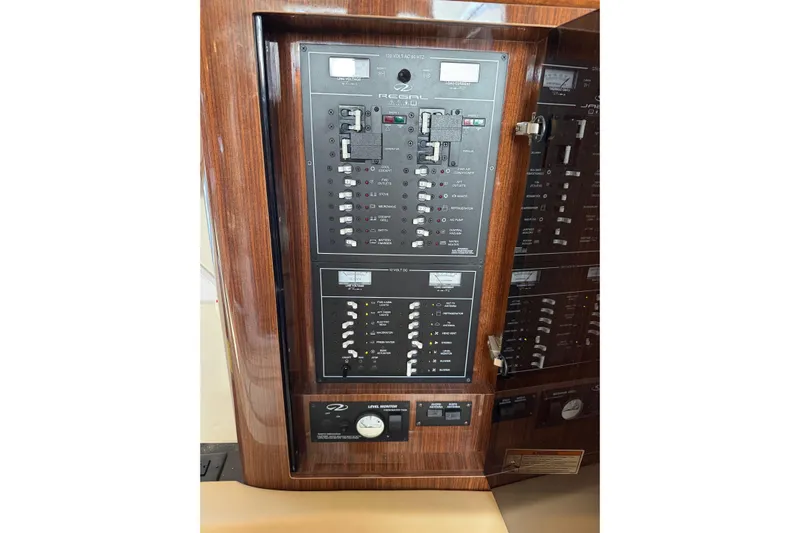  Yacht Photos Pics Control panel of a 2013 Regal 35 Sport Coupe boat with wood finish.