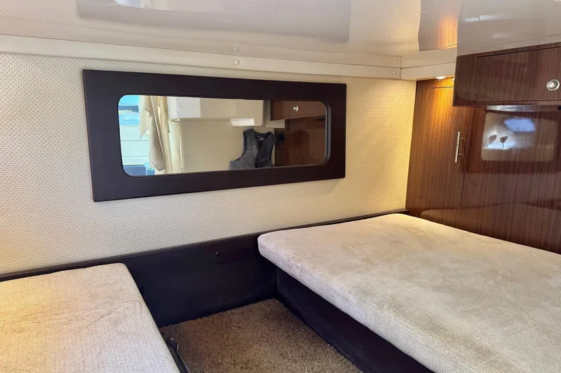  Yacht Photos Pics Interior cabin of 2013 Regal 35 Sport Coupe with twin beds and wooden cabinetry.