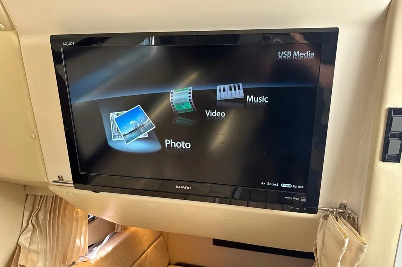  Yacht Photos Pics Sharp TV displaying media options in a 2013 Regal 35 Sport Coupe interior.