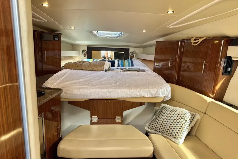  Yacht Photos Pics Luxurious interior of 2013 Regal 35 Sport Coupe with cozy bed and elegant wood cabinetry.