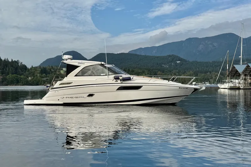 Yacht Photos Pics 2013 Regal 35 Sport Coupe yacht on calm water with scenic mountain backdrop.