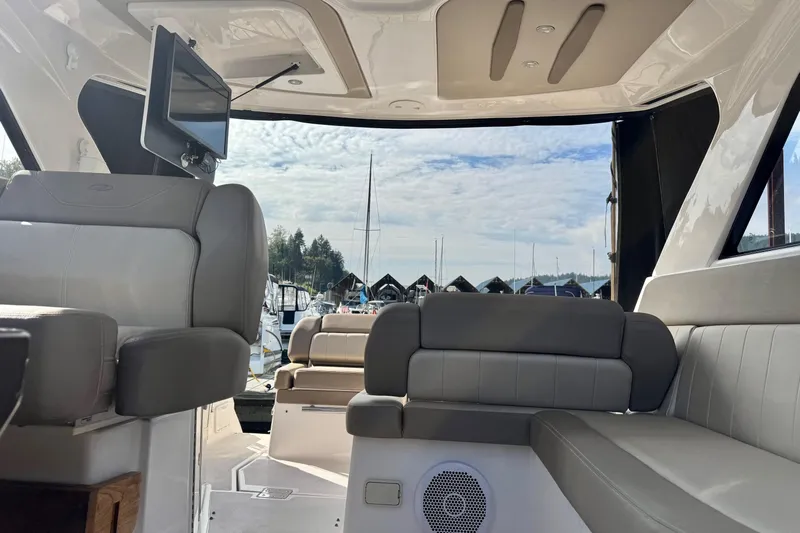  Yacht Photos Pics Interior view of 2013 Regal 35 Sport Coupe yacht with luxurious seating and marina backdrop.