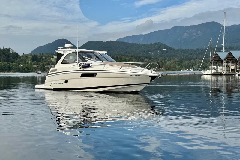  Yacht Photos Pics 2013 Regal 35 Sport Coupe boat on serene lake with mountain backdrop.