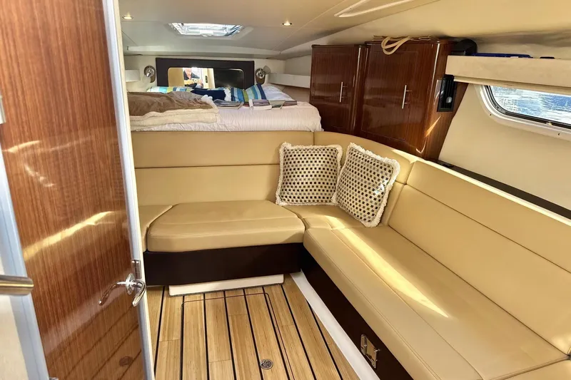  Yacht Photos Pics Luxurious interior of 2013 Regal 35 Sport Coupe with beige seating and wooden accents.