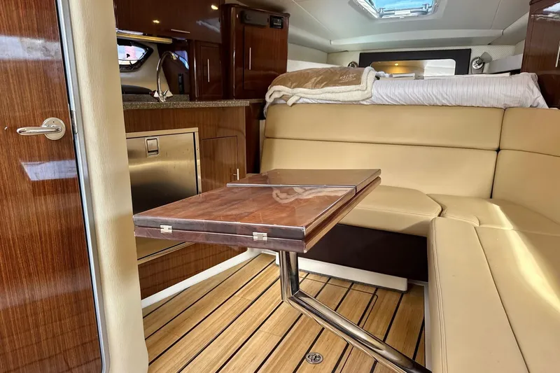  Yacht Photos Pics Luxurious interior of 2013 Regal 35 Sport Coupe with wood accents and beige seating.