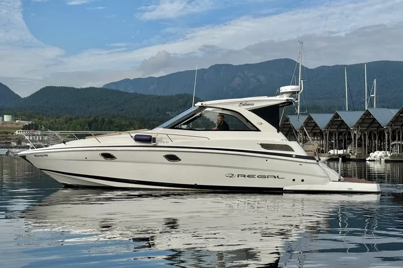  Yacht Photos Pics 2013 Regal 35 Sport Coupe boat on calm water with scenic mountain backdrop.