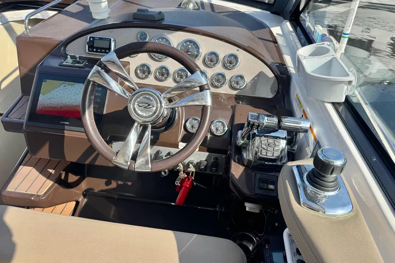  Yacht Photos Pics 2013 Regal 35 Sport Coupe dashboard with steering wheel and navigation controls.
