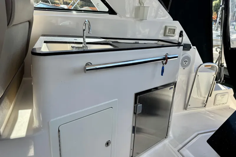 Yacht Photos Pics Interior view of 2013 Regal 35 Sport Coupe with kitchenette and sink.