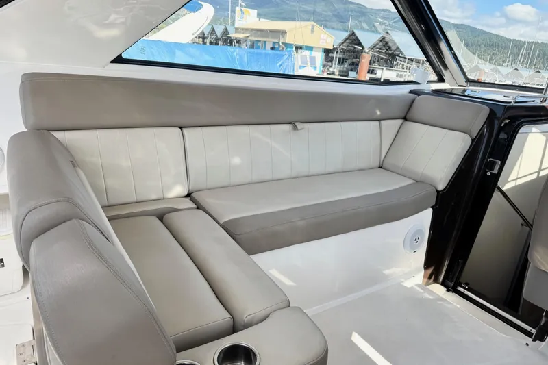  Yacht Photos Pics 2013 Regal 35 Sport Coupe interior with beige leather seating and cup holders.