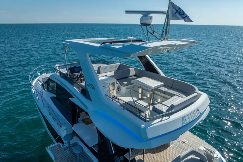  Yacht Photos Pics 2021 Galeon 500 Fly yacht cruising on open sea, featuring spacious upper deck.