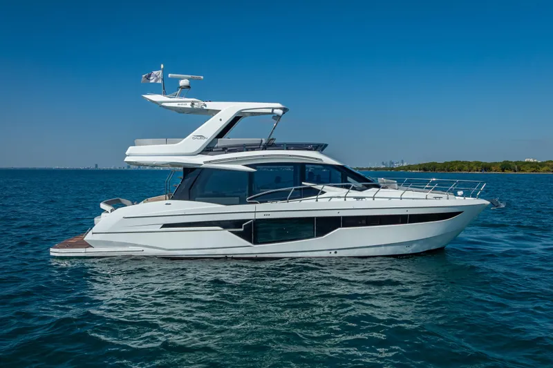  Yacht Photos Pics 2021 Galeon 500 Fly yacht cruising on open water under clear blue skies.