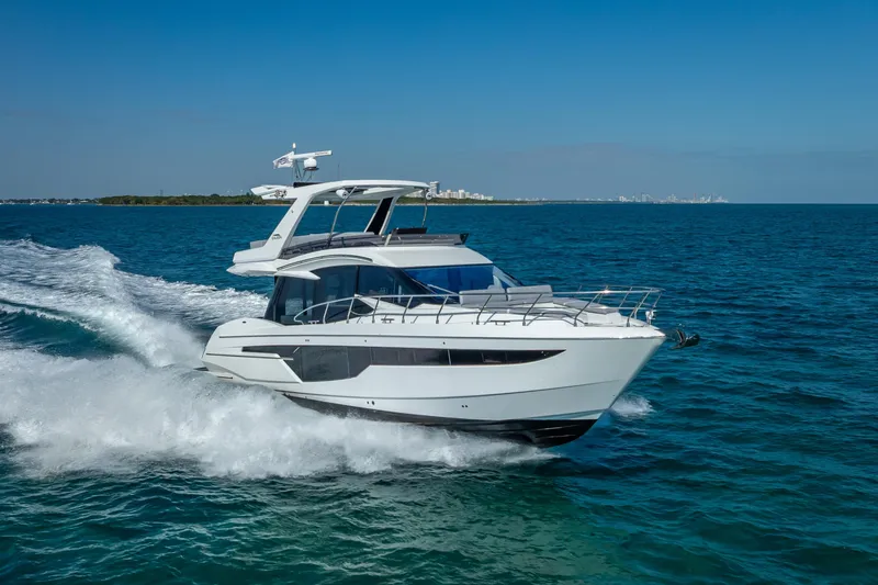  Yacht Photos Pics 2021 Galeon 500 Fly yacht cruising on open water under clear blue skies.