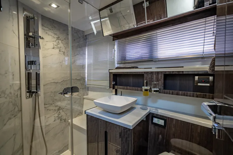  Yacht Photos Pics Luxurious bathroom in 2021 Galeon 500 Fly yacht with modern fixtures and marble accents.