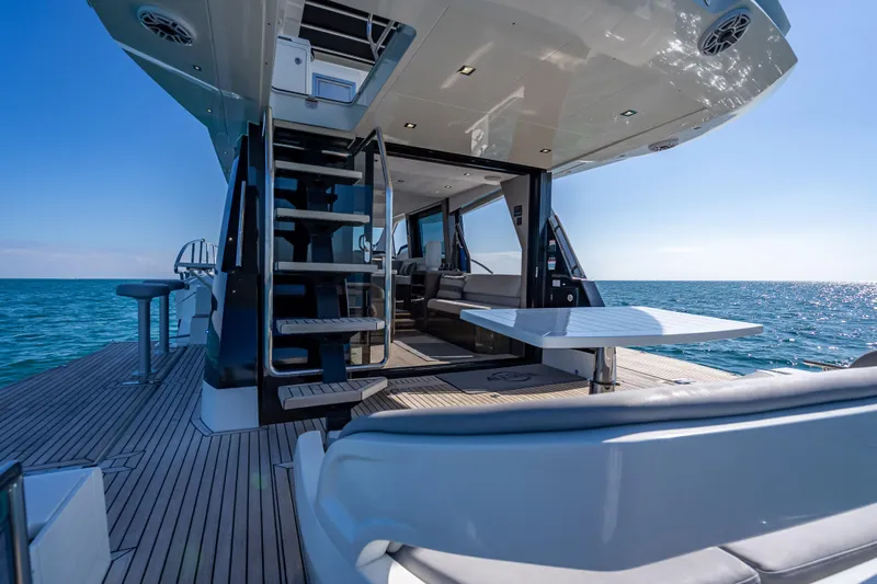  Yacht Photos Pics Luxury 2021 Galeon 500 Fly yacht deck with ocean view, featuring modern seating and staircase.