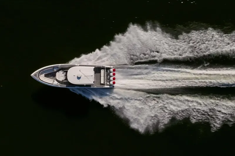  Yacht Photos Pics Aerial view of 2020 Fountain 43 NX boat speeding on water.