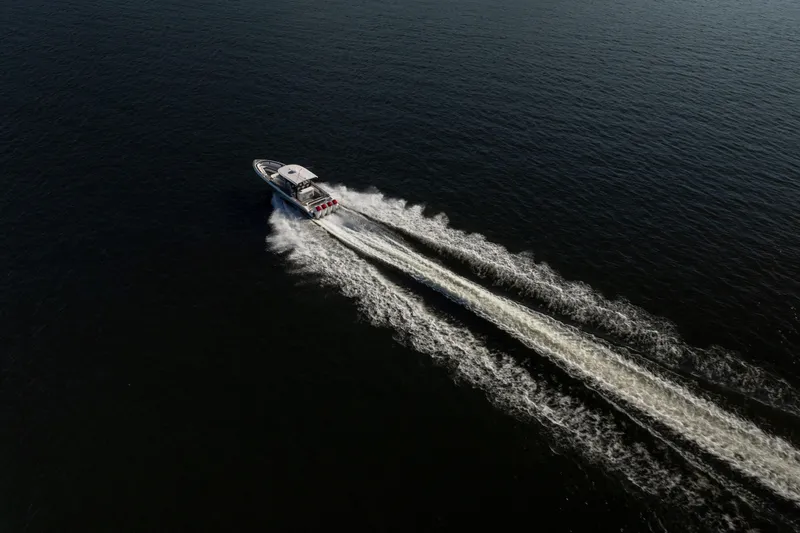  Yacht Photos Pics Aerial view of 2020 Fountain 43 NX speedboat cruising on open water.