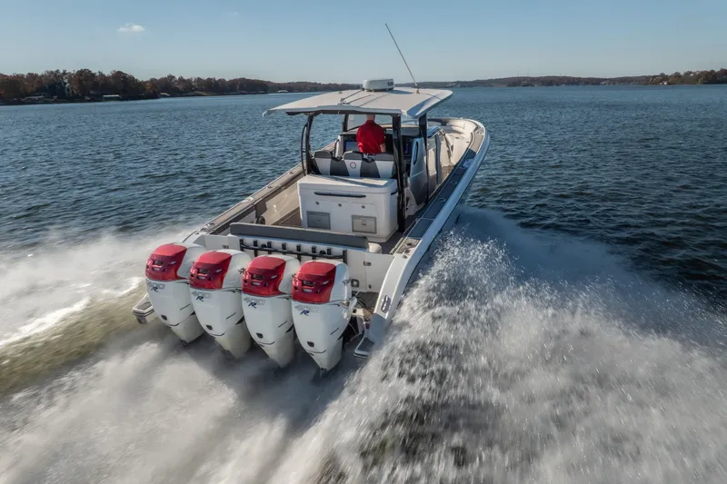  Yacht Photos Pics 2020 Fountain 43 NX boat with four engines cruising on a lake.