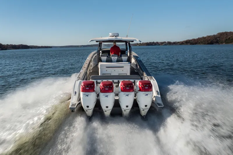  Yacht Photos Pics 2020 Fountain 43 NX boat with four powerful outboard engines cruising on a lake.