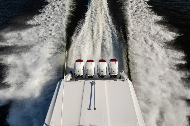  Yacht Photos Pics 2020 Fountain 43 NX boat with four engines creating wake on water.