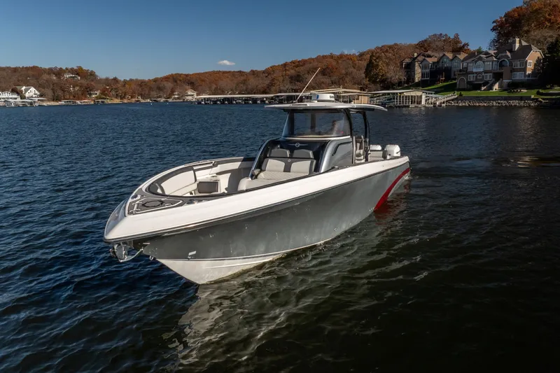  Yacht Photos Pics 2020 Fountain 43 NX boat on a serene lake with autumn foliage background.