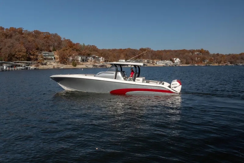  Yacht Photos Pics 2020 Fountain 43 NX boat cruising on a lake with autumn foliage background.