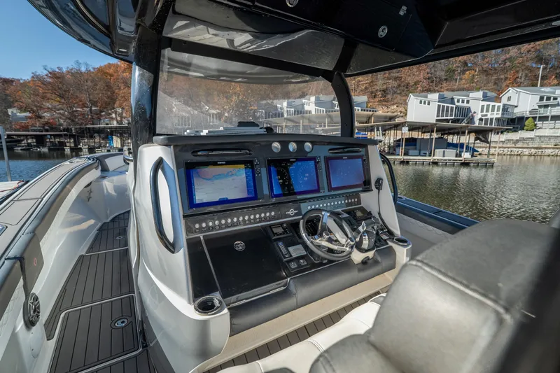  Yacht Photos Pics 2020 Fountain 43 NX boat cockpit with advanced navigation systems and luxurious seating.