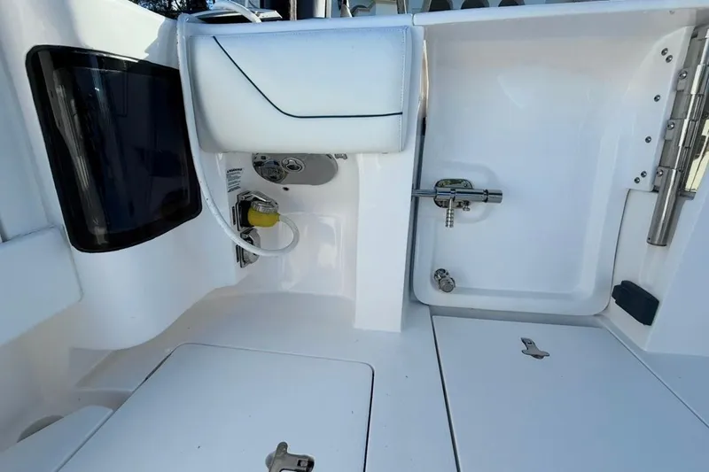  Yacht Photos Pics 2022 Intrepid 407 Panacea boat interior with storage compartments and sleek design.