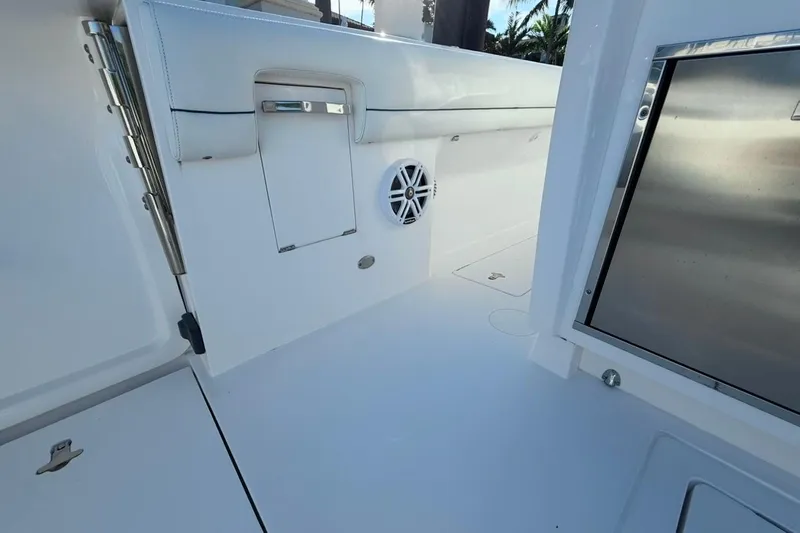  Yacht Photos Pics 2022 Intrepid 407 Panacea boat interior with sleek white design and stainless steel accents.