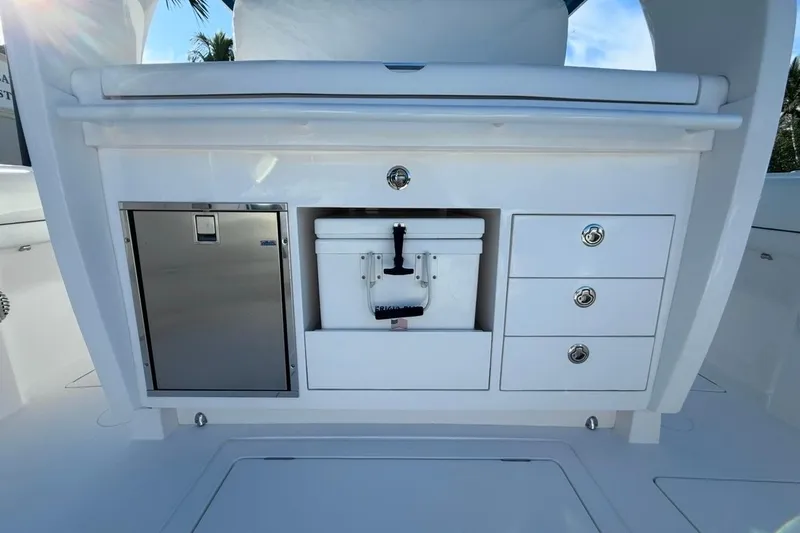  Yacht Photos Pics 2022 Intrepid 407 Panacea boat interior with storage drawers and cooler.