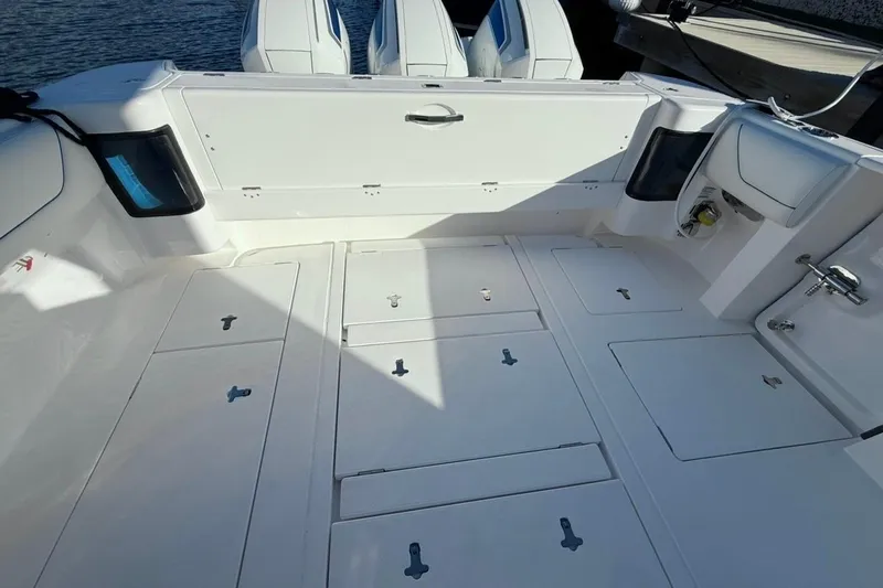  Yacht Photos Pics 2022 Intrepid 407 Panacea boat deck with storage compartments and triple engines.