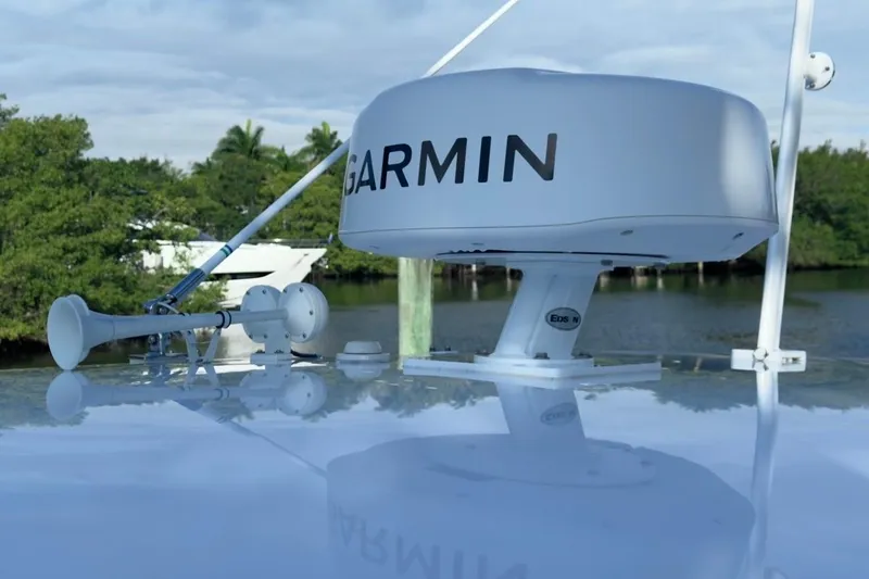  Yacht Photos Pics 2022 Intrepid 407 Panacea with Garmin radar, docked near lush greenery.