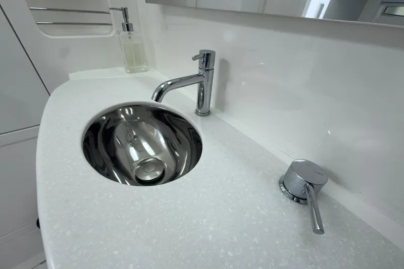  Yacht Photos Pics Modern bathroom sink in 2022 Intrepid 407 Panacea boat, featuring sleek chrome fixtures.