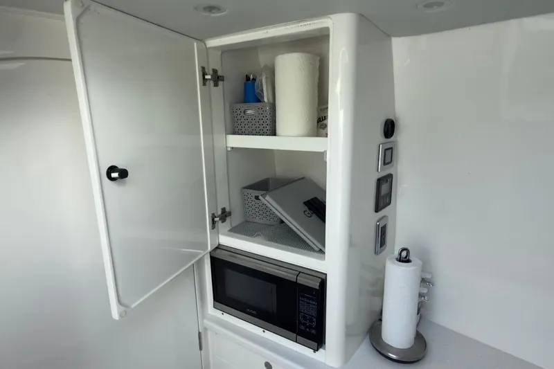  Yacht Photos Pics Cabinet interior with microwave and storage in 2022 Intrepid 407 Panacea boat.