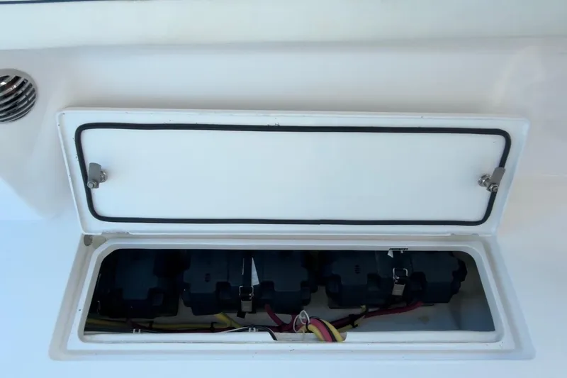  Yacht Photos Pics Open storage compartment on 2022 Intrepid 407 Panacea boat, showing electrical components.