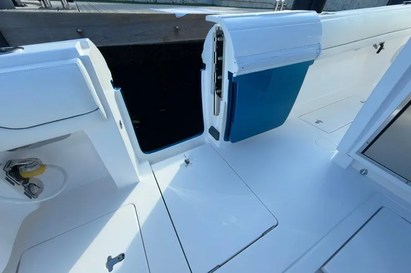  Yacht Photos Pics 2022 Intrepid 407 Panacea boat interior with open storage compartment and sleek design.