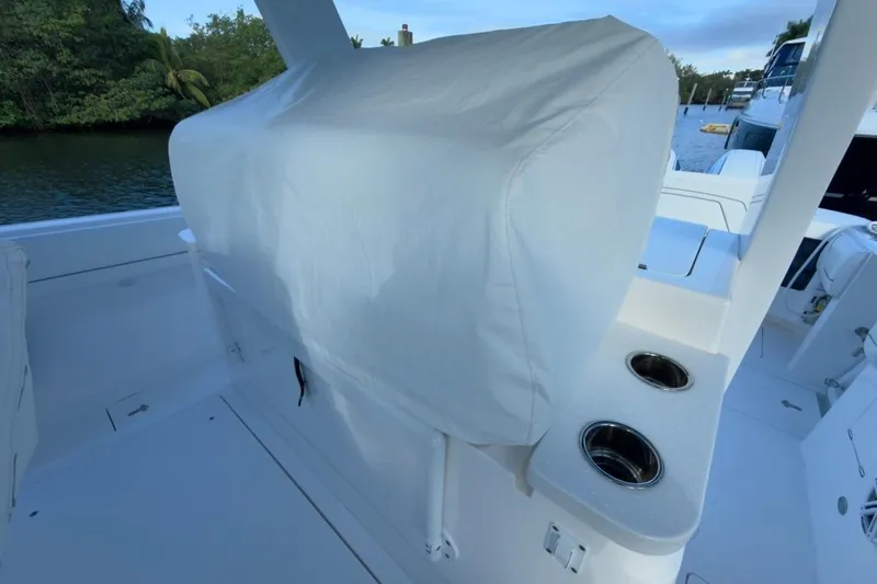  Yacht Photos Pics 2022 Intrepid 407 Panacea boat interior with covered seating and cup holders.