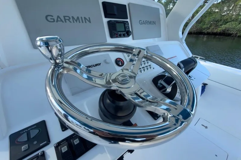  Yacht Photos Pics Steering wheel and controls of 2022 Intrepid 407 Panacea boat with Garmin displays.