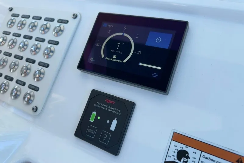  Yacht Photos Pics Control panel of 2022 Intrepid 407 Panacea featuring Seakeeper and fire suppression system.