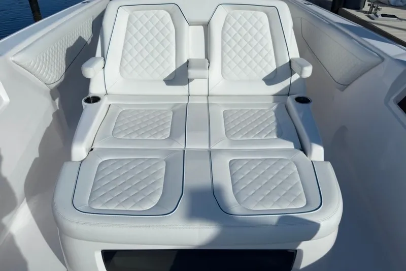  Yacht Photos Pics Luxurious white seating on 2022 Intrepid 407 Panacea boat, featuring quilted upholstery.