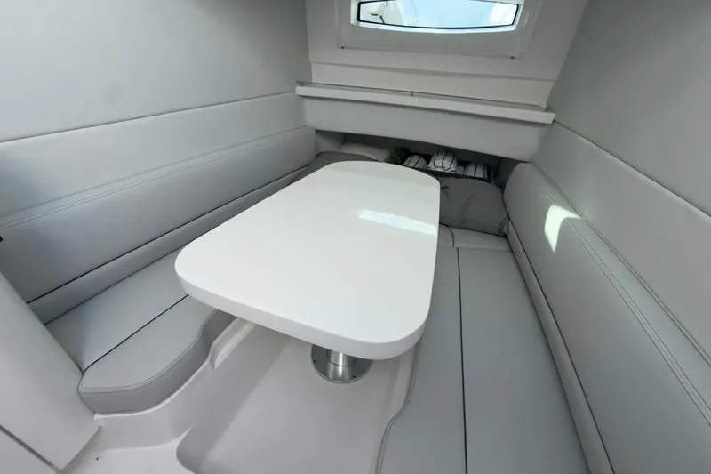  Yacht Photos Pics Interior of 2022 Intrepid 407 Panacea boat with sleek white seating and table.