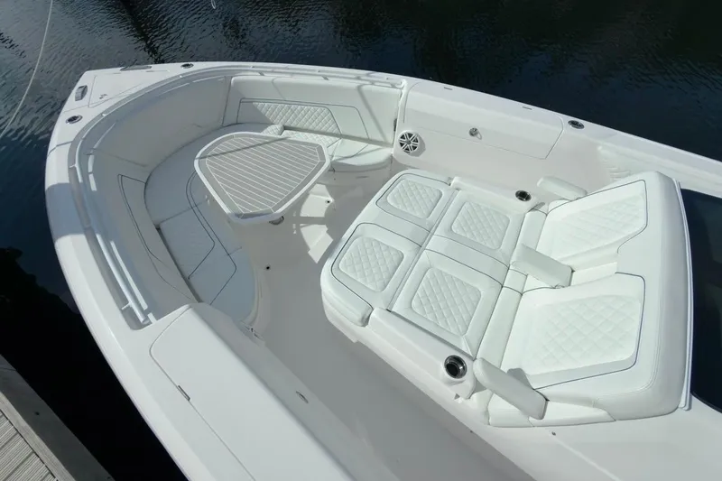  Yacht Photos Pics Luxurious seating area on 2022 Intrepid 407 Panacea boat, featuring white cushioned seats.