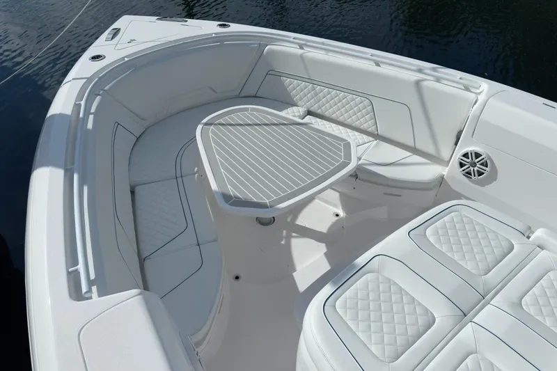  Yacht Photos Pics Luxurious seating area on 2022 Intrepid 407 Panacea boat with quilted cushions and table.
