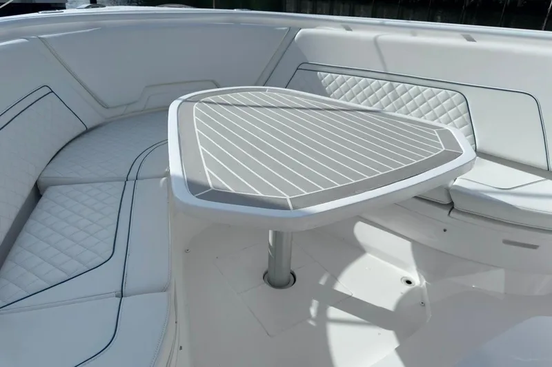  Yacht Photos Pics Luxurious seating area on 2022 Intrepid 407 Panacea boat with stylish table and cushions.