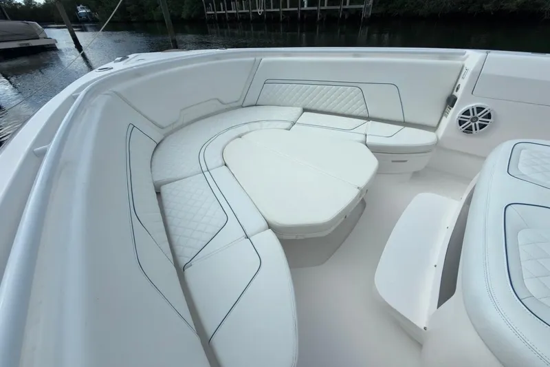  Yacht Photos Pics Luxurious seating area on 2022 Intrepid 407 Panacea boat, featuring white cushioned seats.